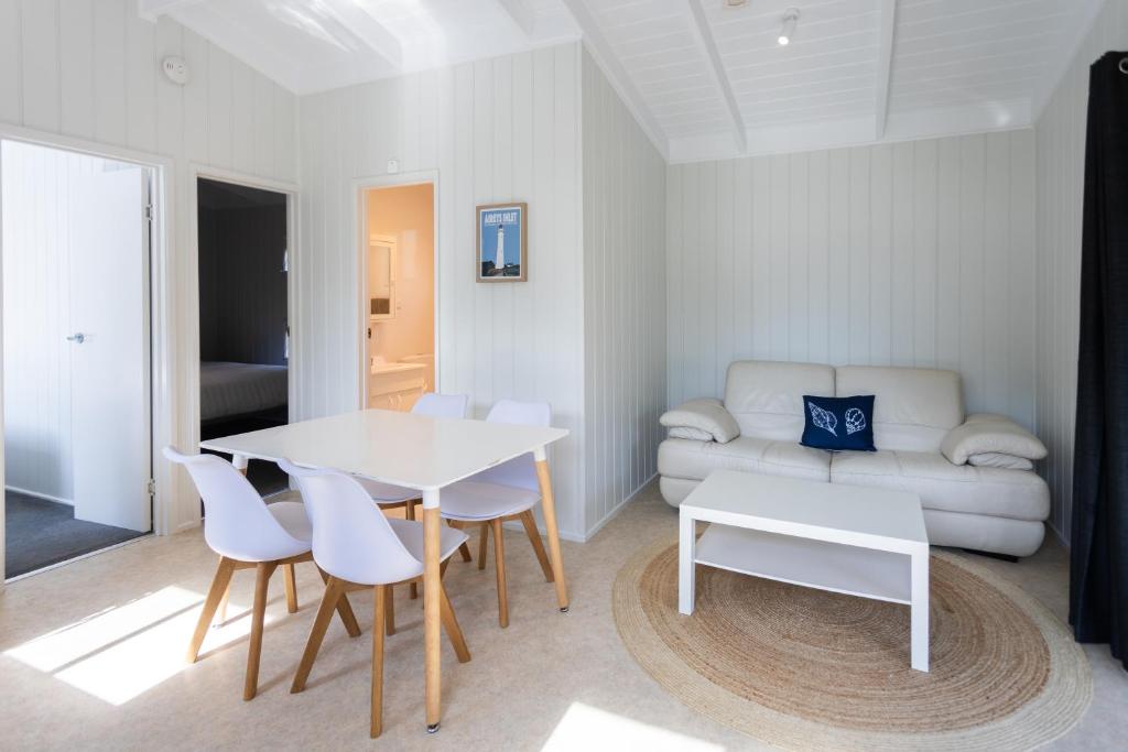 a living room with a table and chairs and a couch at Pet Friendly Stays - BIG4 Aireys Inlet in Aireys Inlet