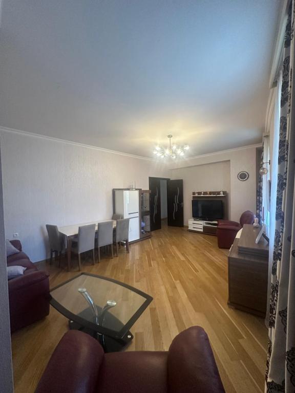 a living room with a couch and a table at Central Park Apartment in Tbilisi City