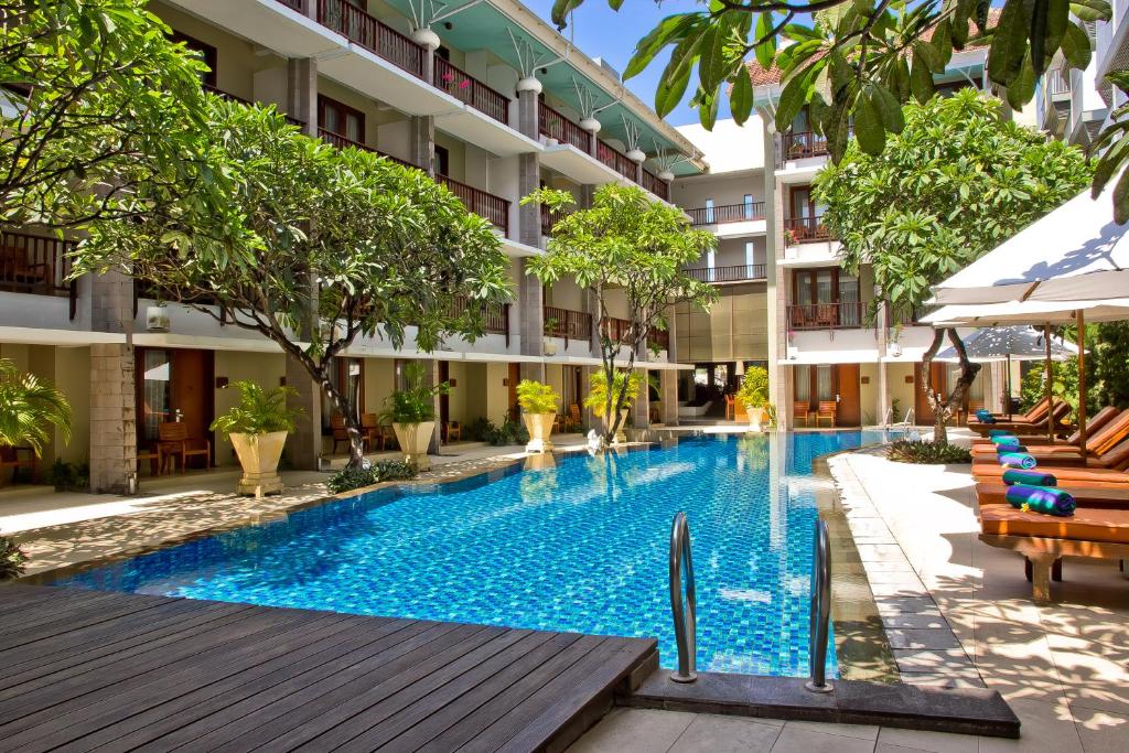 a swimming pool in the middle of a building at The Rani Hotel & Spa in Kuta
