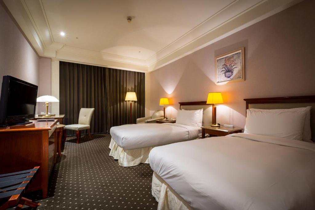 Postel nebo postele na pokoji v ubytování Grand View Hotel