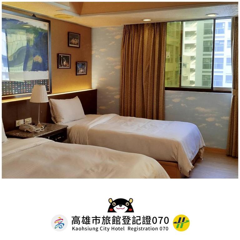 a hotel room with two beds and a window at Katherine Plaza Hotel in Kaohsiung