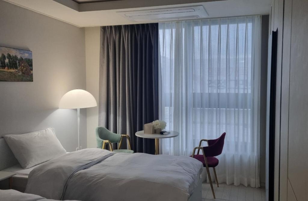 a hotel room with a bed and a window at Daegu DSR Business Hotel in Daegu
