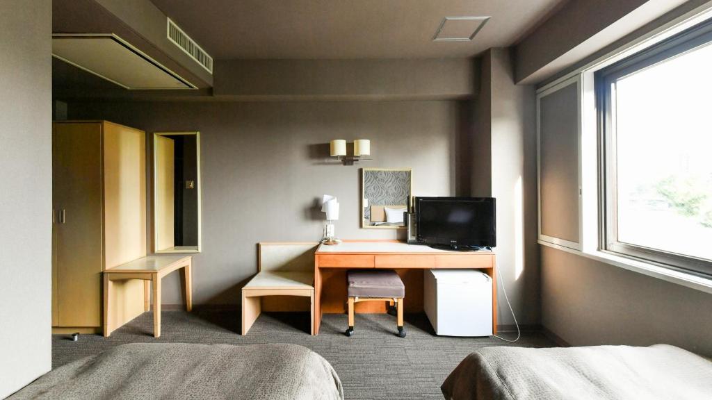 Postel nebo postele na pokoji v ubytování Okazaki Daiichi Hotel
