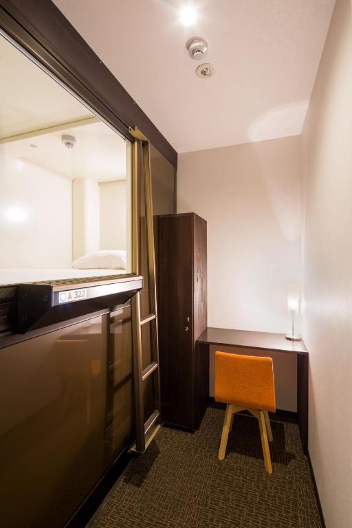 Postel nebo postele na pokoji v ubytování Capsule Hotel Cube Hiroshima