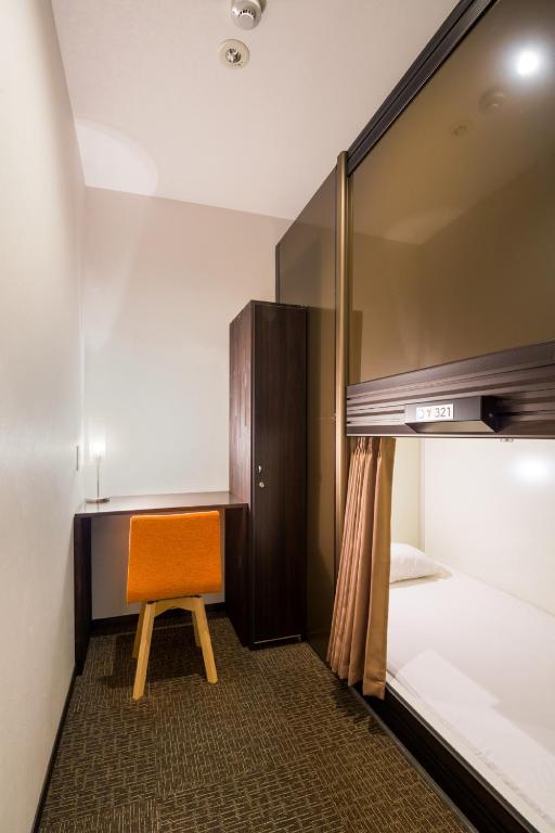 Postel nebo postele na pokoji v ubytování Capsule Hotel Cube Hiroshima