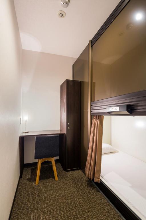 Postel nebo postele na pokoji v ubytování Capsule Hotel Cube Hiroshima