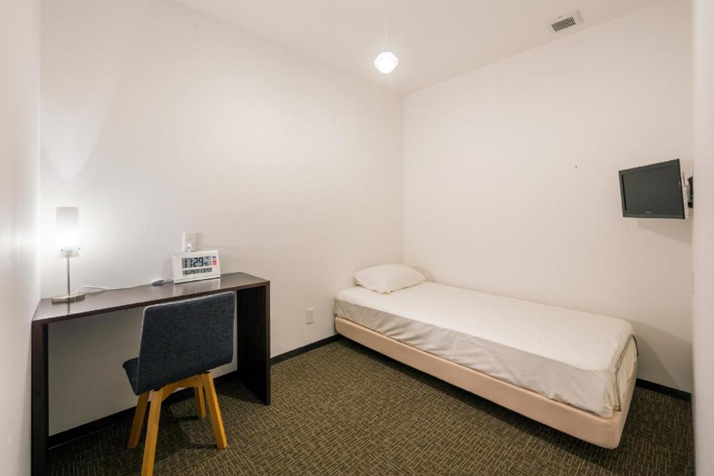 Postel nebo postele na pokoji v ubytování Capsule Hotel Cube Hiroshima