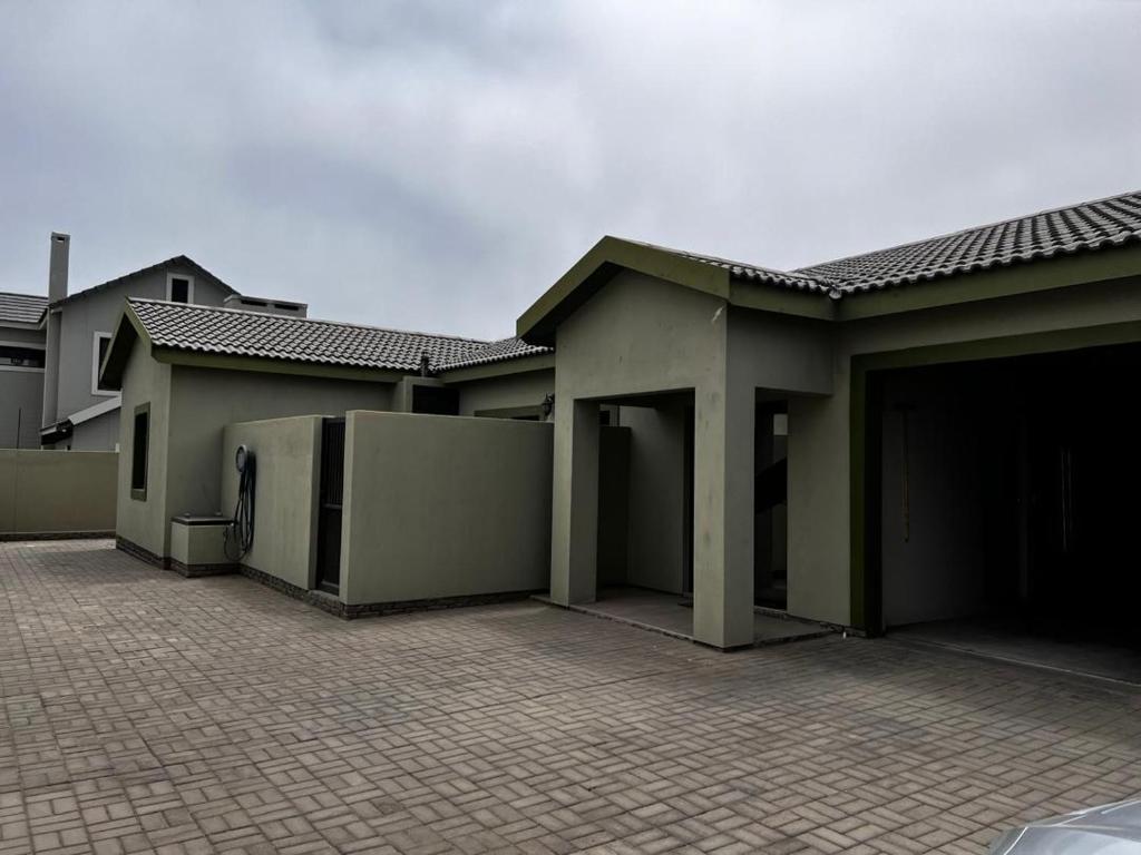 a house with two garages and a parking lot at The Lofty-Nest of Leadwood Street in Swakopmund