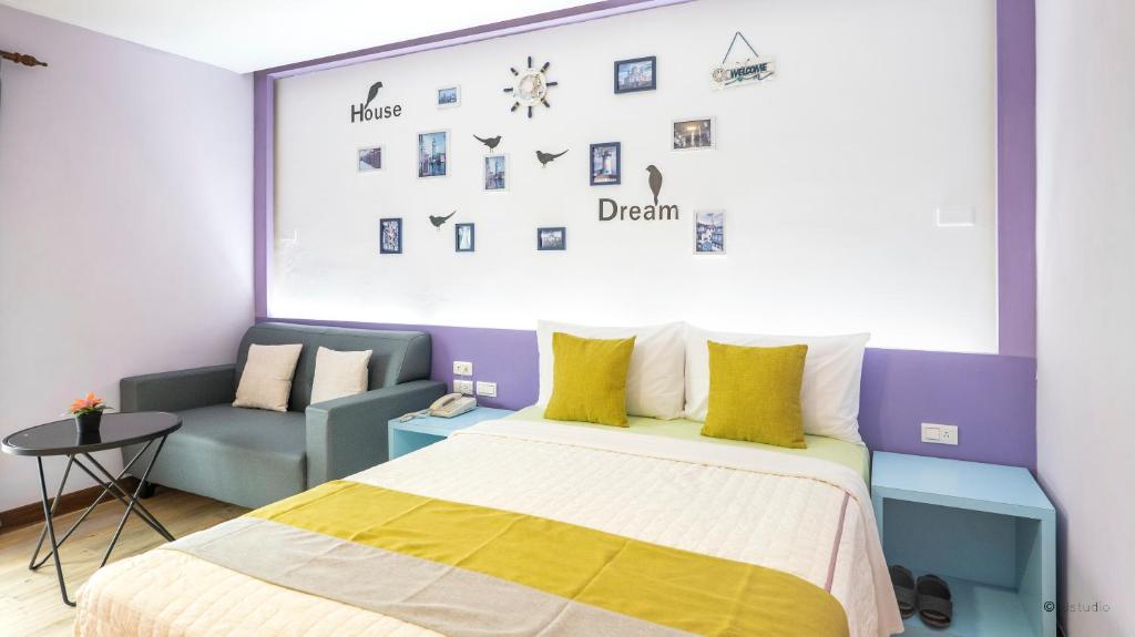 a bedroom with a bed and a couch in it at Ocean Star B&B in Kenting