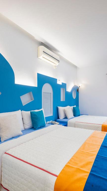two beds in a room with blue walls at Ocean Star B&B in Kenting