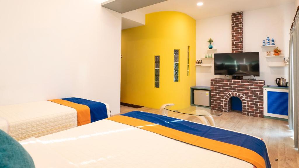 a bedroom with two beds and a fireplace at Ocean Star B&B in Kenting