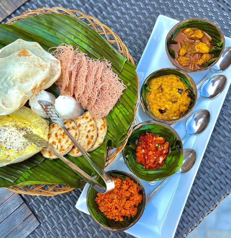 a plate of food with different types of food at The Theva Residency in Kandy