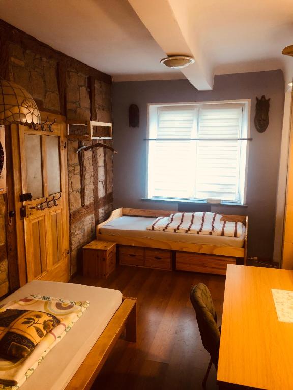 a room with a bed and a window and a table at Wohnung 40 Quadratmeter in Arnstein