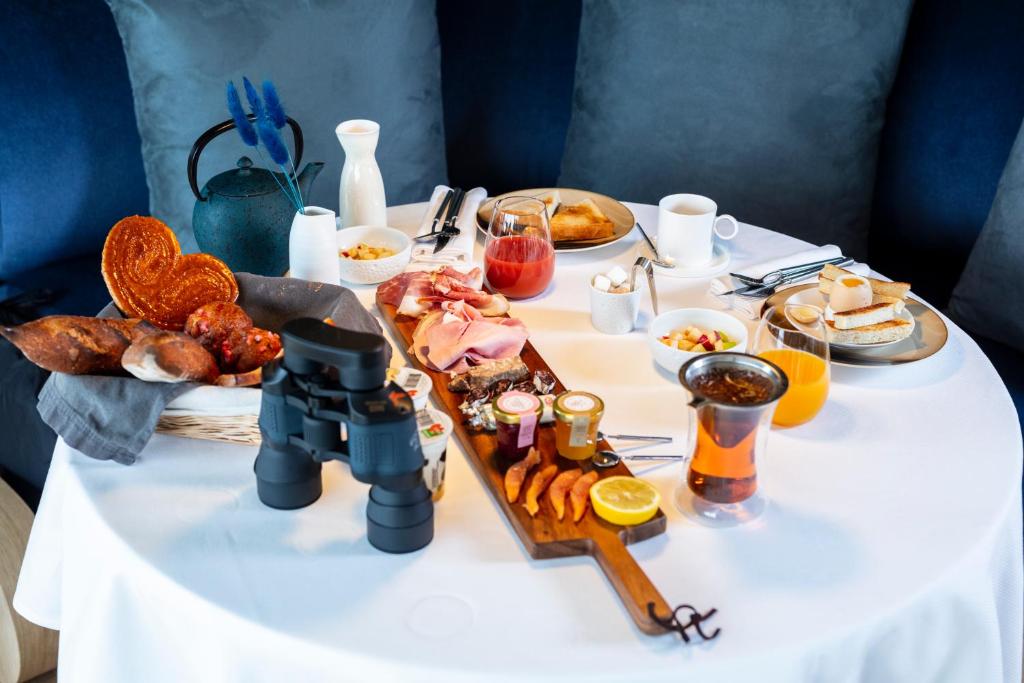 a table with food and a camera on it at Hôtel & Restaurant Origines par Adrien Descouls - Teritoria in Issoire