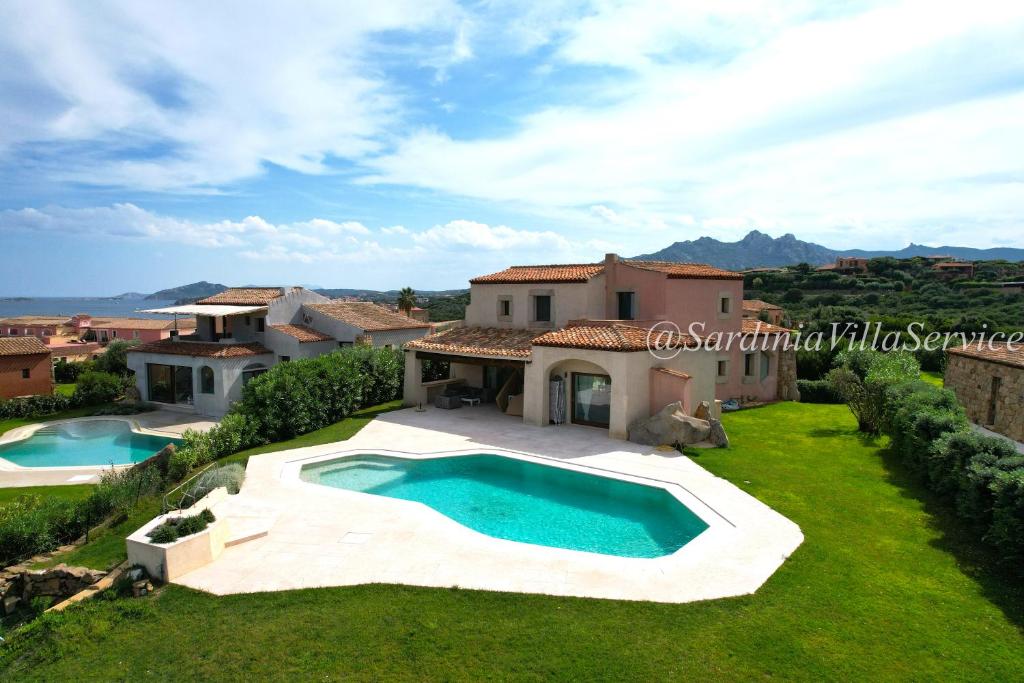 an external view of a villa with a swimming pool at Villa Lighthouse 6 - Porto Cervo in Porto Cervo