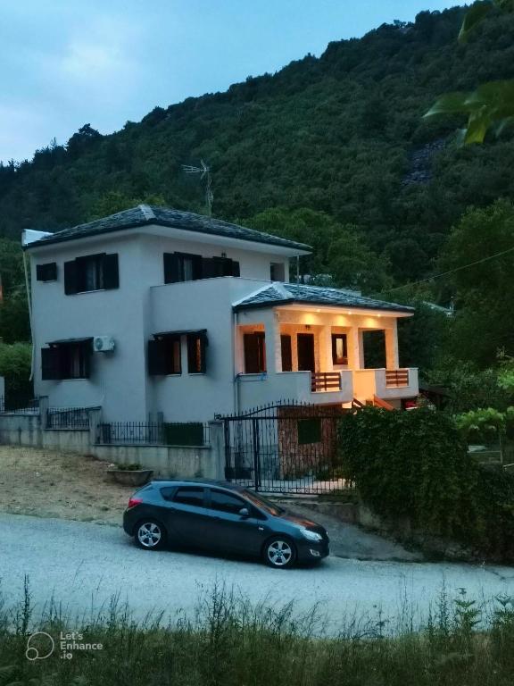 a black car parked in front of a house at Villa Malila in Panagia