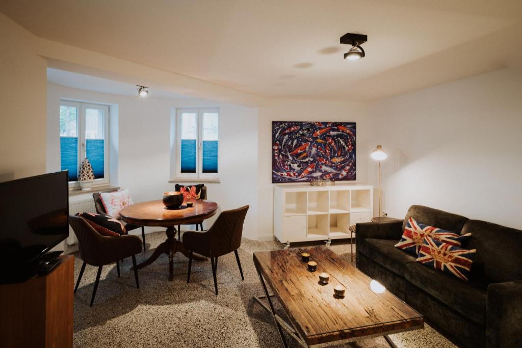 a living room with a couch and a table at Appartements EICHENHOF in Bad Salzuflen