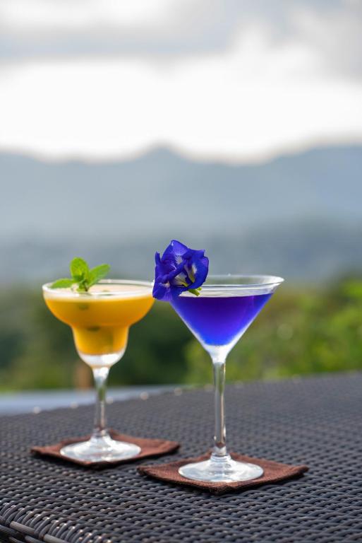 two cocktails sitting on top of a table at The Theva Residency in Kandy