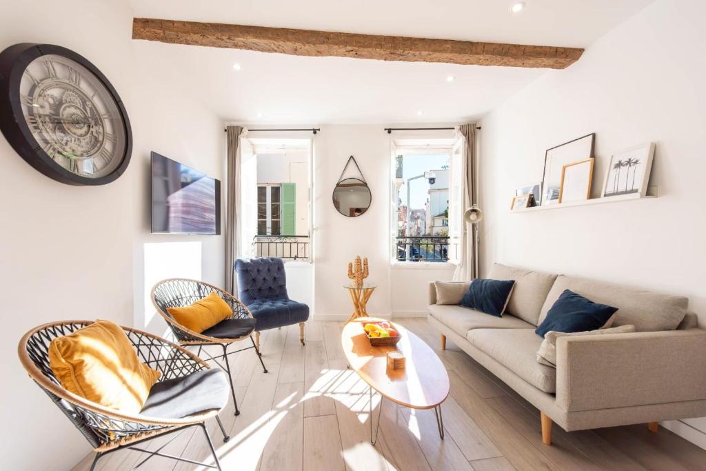 - un salon avec un canapé, des chaises et un réveil dans l'établissement 3P Central Cannes Suquet, à Cannes