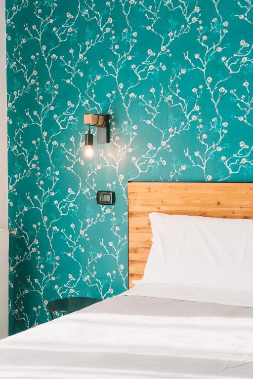 a bedroom with a bed and a blue wall at TRAVEL STATION Bedandbreakfast in Bari