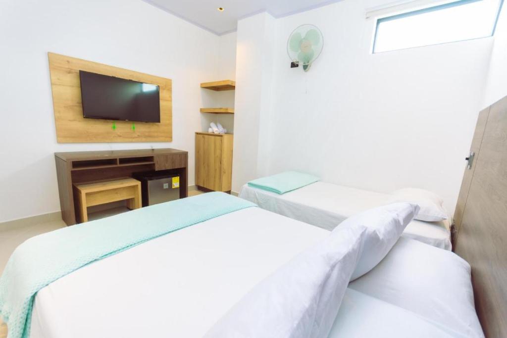 Postel nebo postele na pokoji v ubytování Hotel Luna Verde