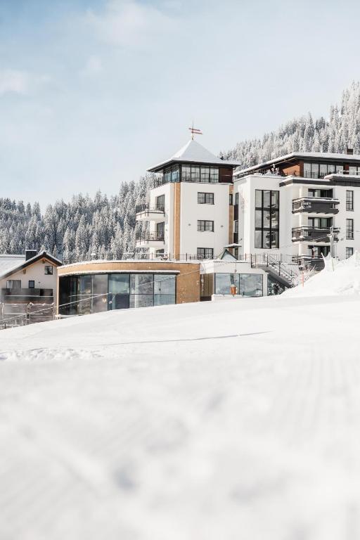 a view of a building with snow on the ground at Schlosshotel Fiss in Fiss
