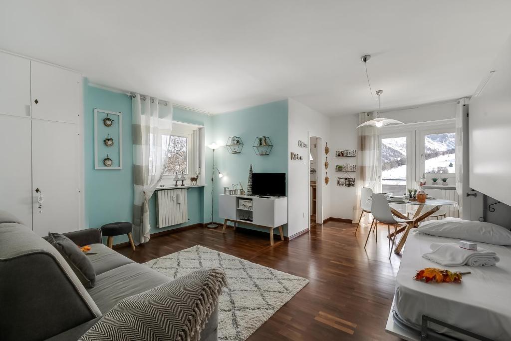 a living room with a couch and a table at Studio Blue Petit - Happy Rentals in Sestriere