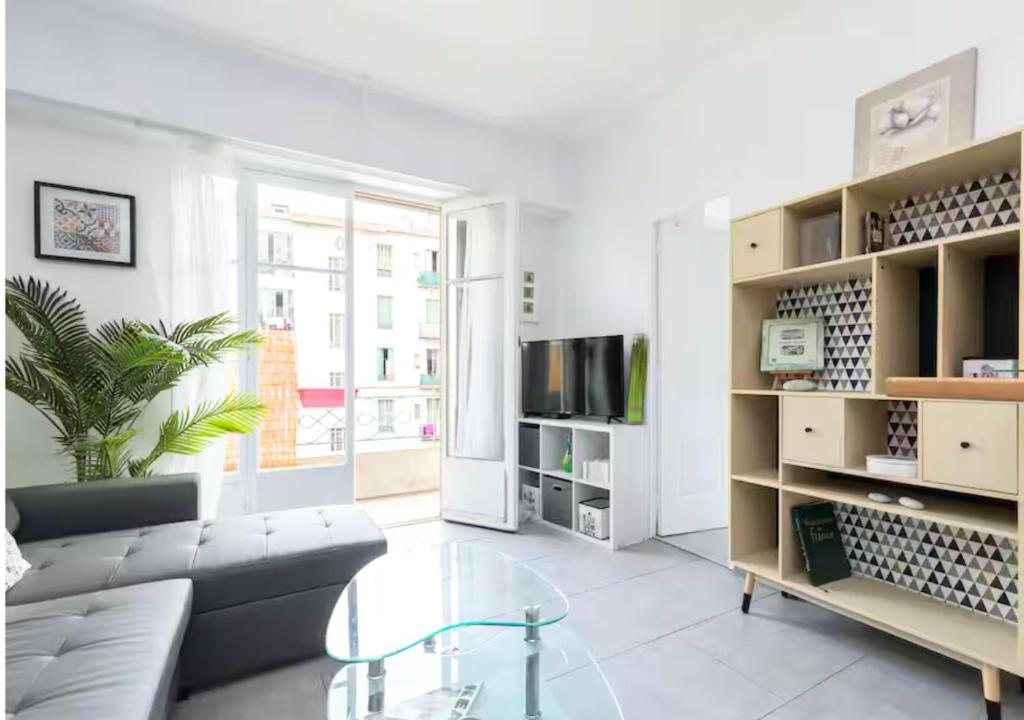 un salon avec un canapé et une table en verre dans l'établissement Beautiful & spacious 2 bed Apt near Nice Center, à Nice
