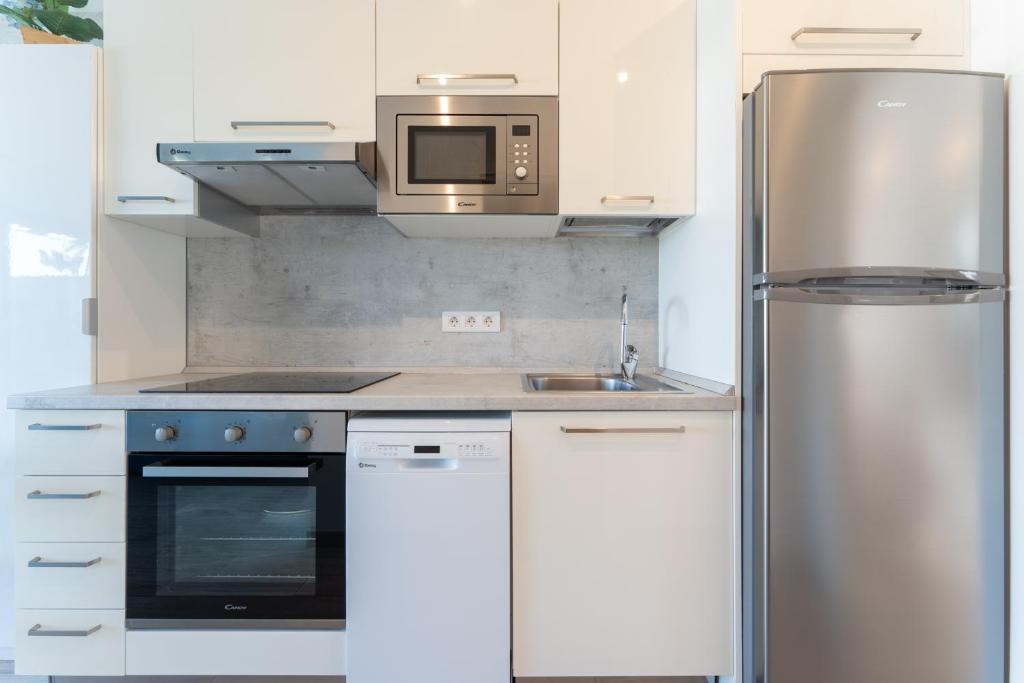 A kitchen or kitchenette at Luxury Poolside Holiday Home