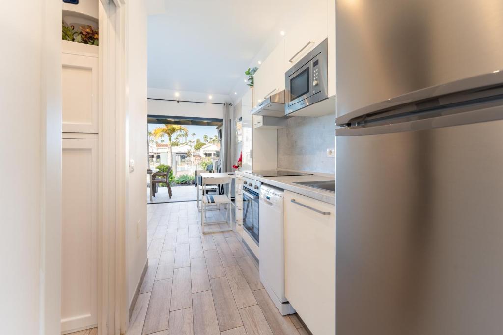 A kitchen or kitchenette at Luxury Poolside Holiday Home