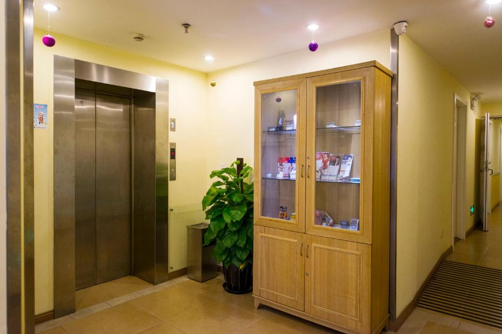 un couloir avec une armoire en bois dans un bâtiment dans l'établissement Home Inn Xi'an Bell Tower Luomashi Pedestrian Street, à Xi'an