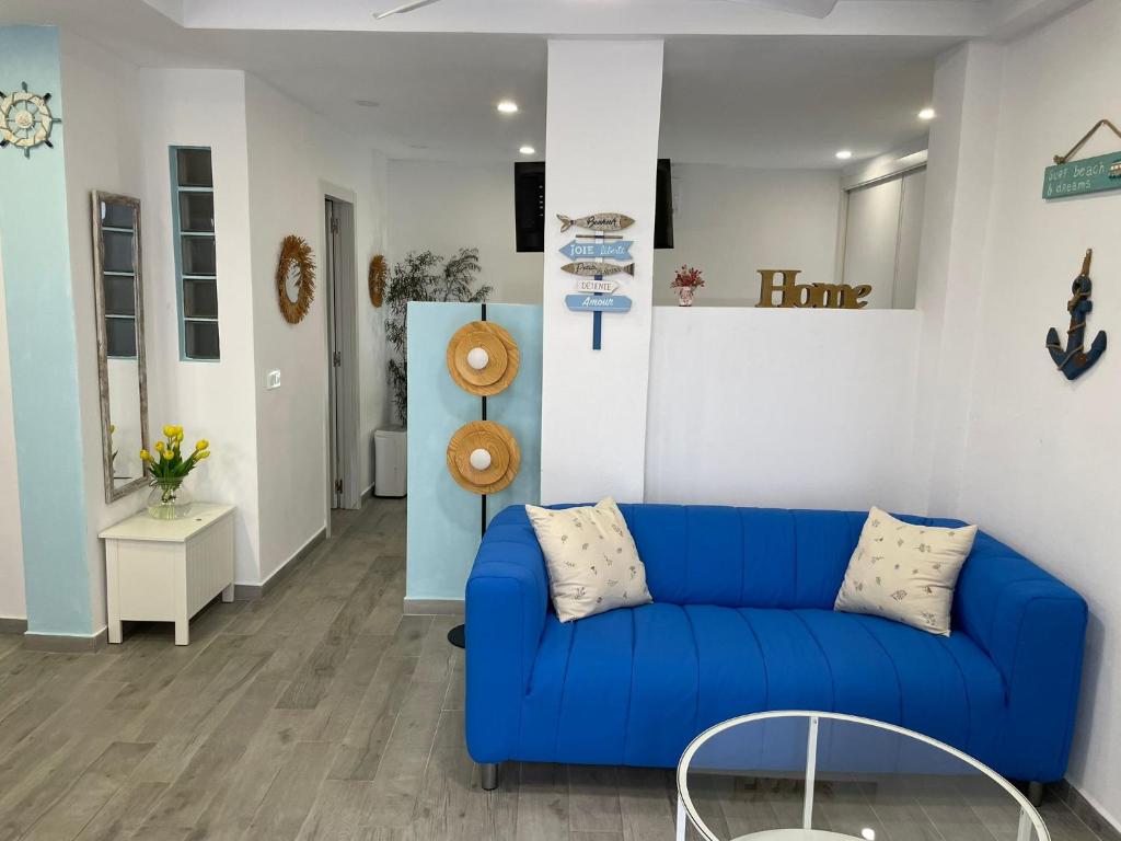 a living room with a blue couch and a table at El rincon de Mauro in Altea