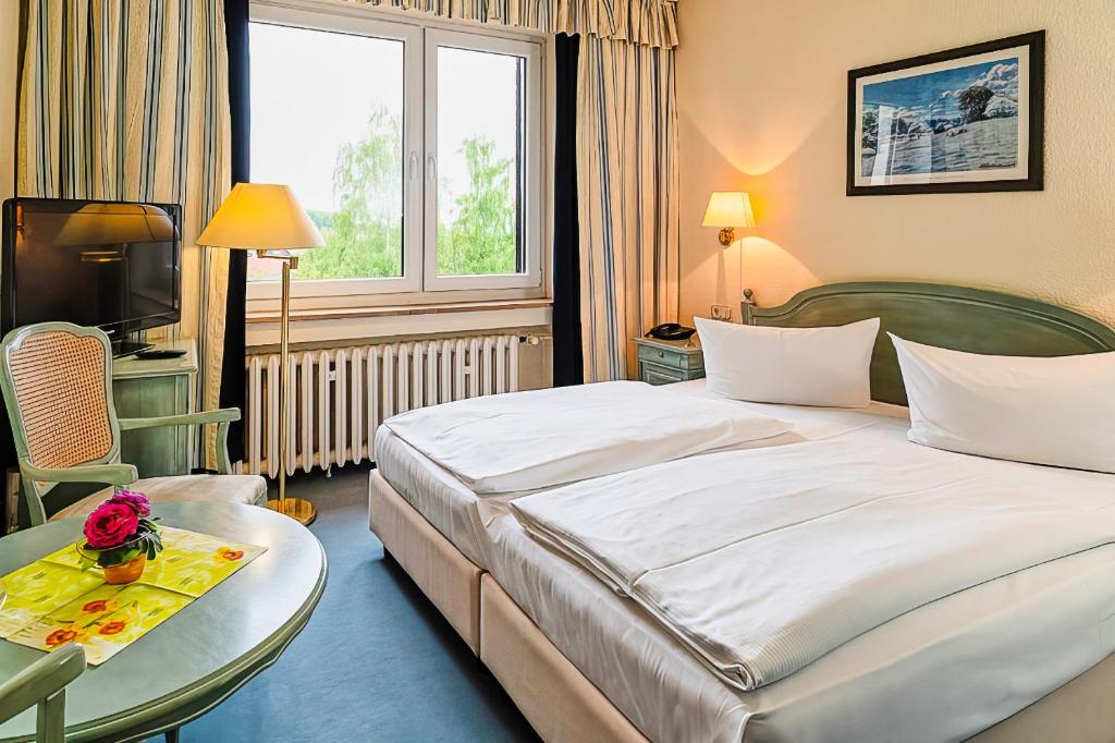 Postel nebo postele na pokoji v ubytování Wagners Hotel im Thüringer Wald