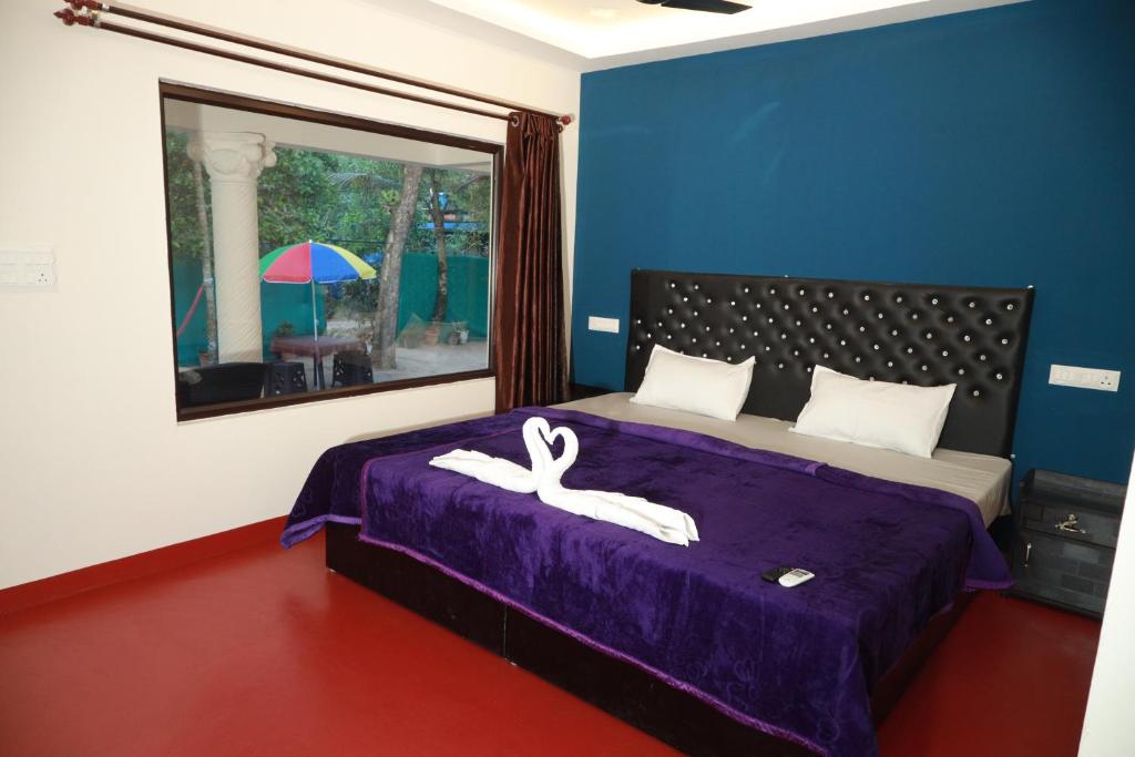 a bedroom with a bed with a swan decoration on it at Kadal beach house marari in Mararikulam