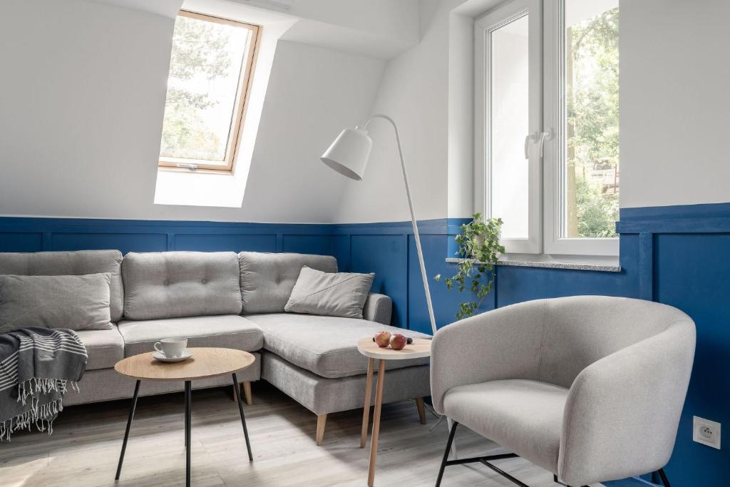 a living room with a couch and a chair at Pensjonat Vyspa Gdynia in Gdynia