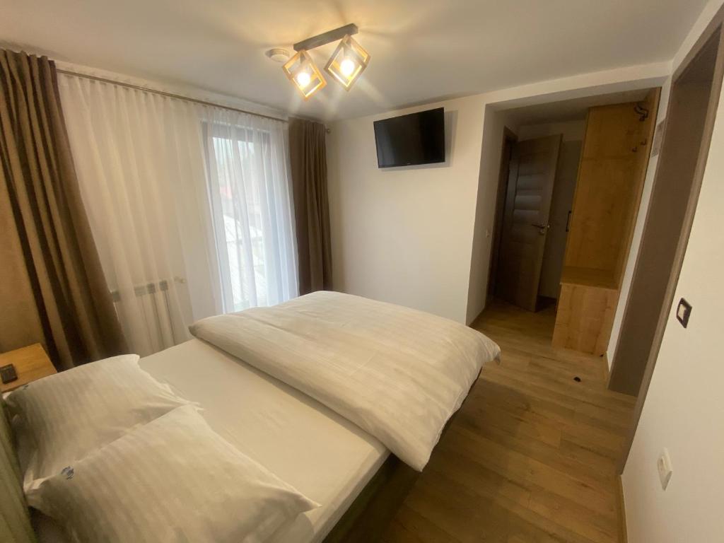 Postel nebo postele na pokoji v ubytování Pensiunea Casa Pancu
