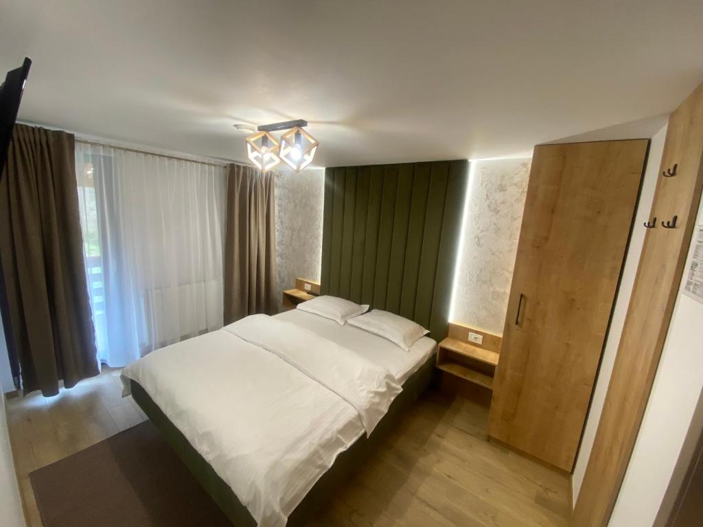Postel nebo postele na pokoji v ubytování Pensiunea Casa Pancu