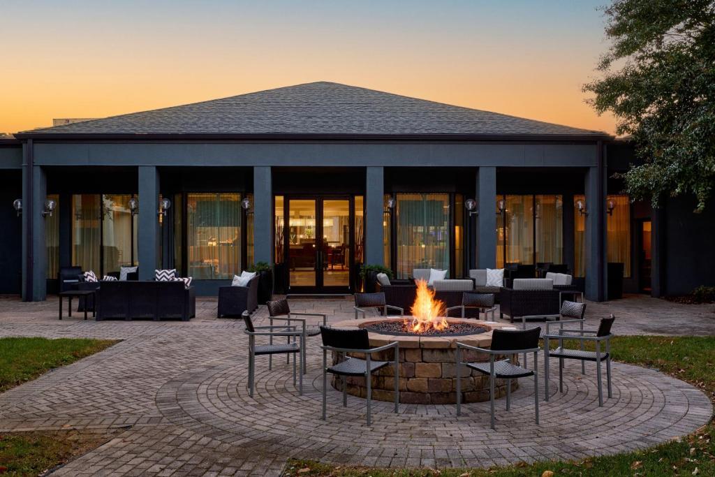 a fire pit with chairs and tables in front of a building at Courtyard by Marriott Fairfax Fair Oaks in Fairfax