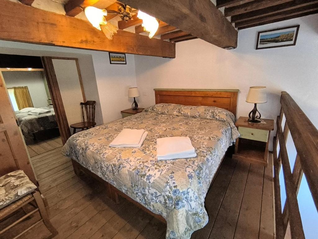 a bedroom with a bed with two towels on it at 23 Mountain Views & Poolside Bliss Wi-Fi and Parking Free! in Castel del Piano
