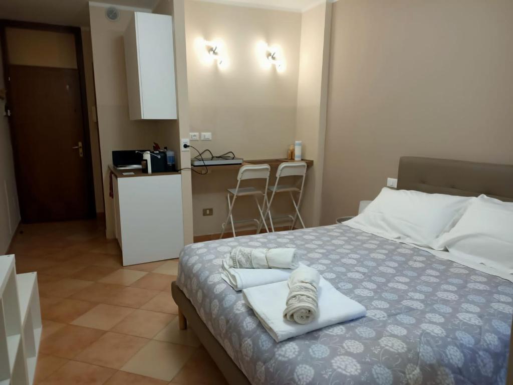 a bedroom with a bed with two towels on it at La Rosa Cesena in Cesena
