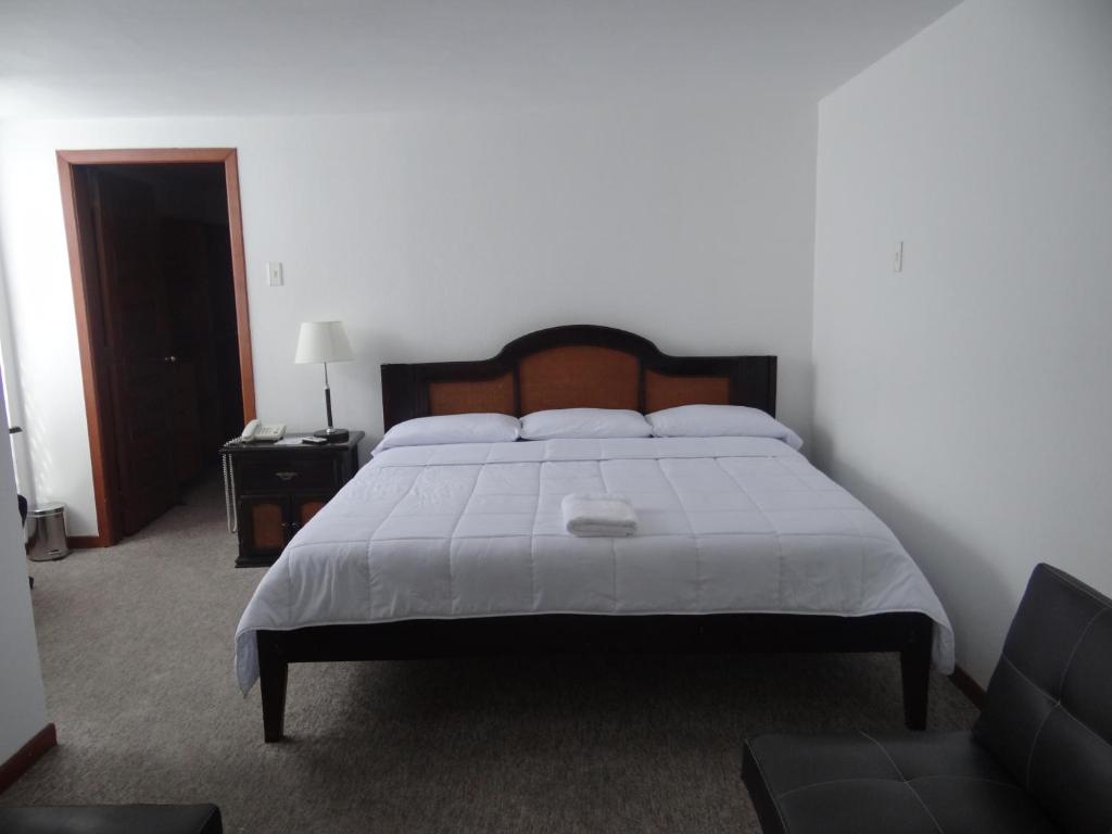 Postel nebo postele na pokoji v ubytování Altura Rooms & Suites