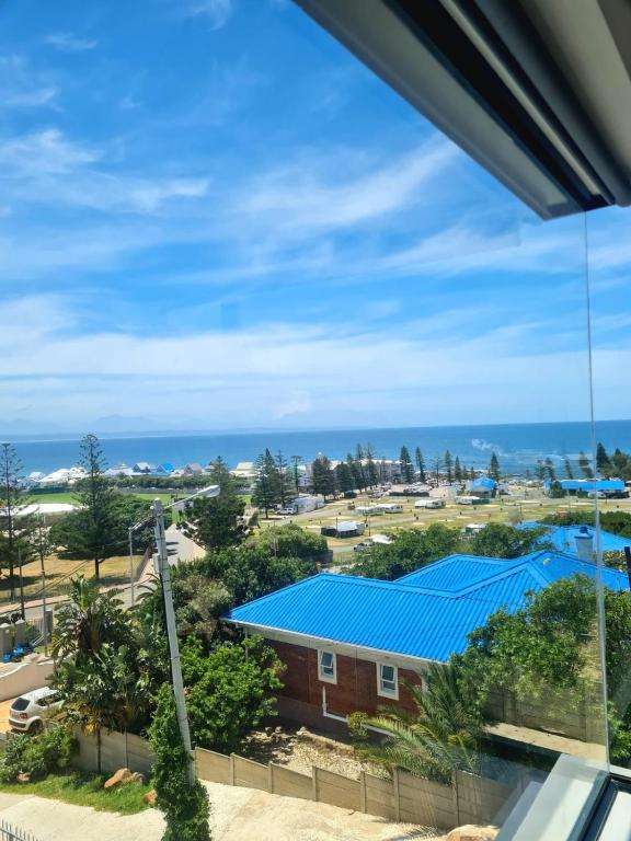a view from the balcony of a building with a blue roof at Montagu Villa 3 in Mossel Bay