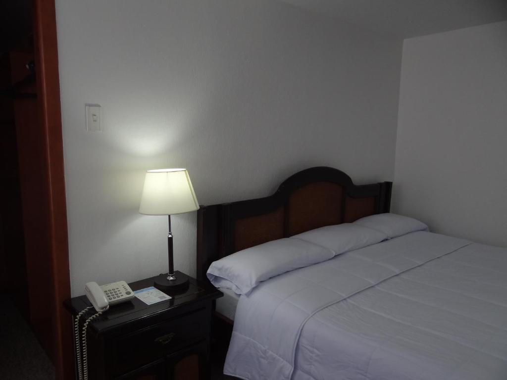 Postel nebo postele na pokoji v ubytování Altura Rooms & Suites