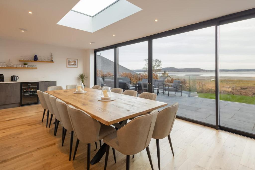 a dining room with a large wooden table and chairs at Host & Stay - Bay View House in Grange Over Sands