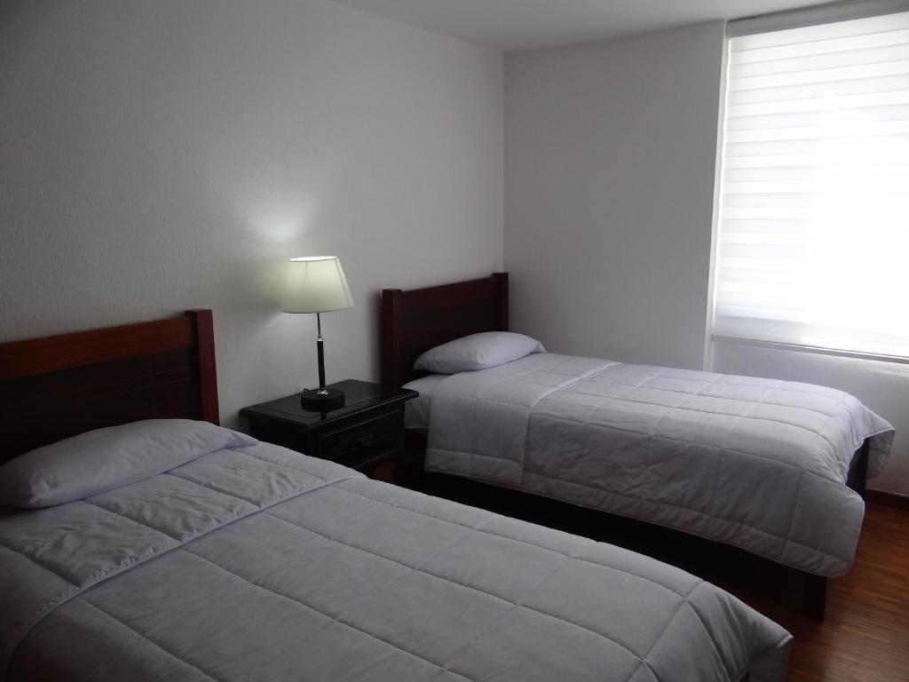 Postel nebo postele na pokoji v ubytování Altura Rooms & Suites