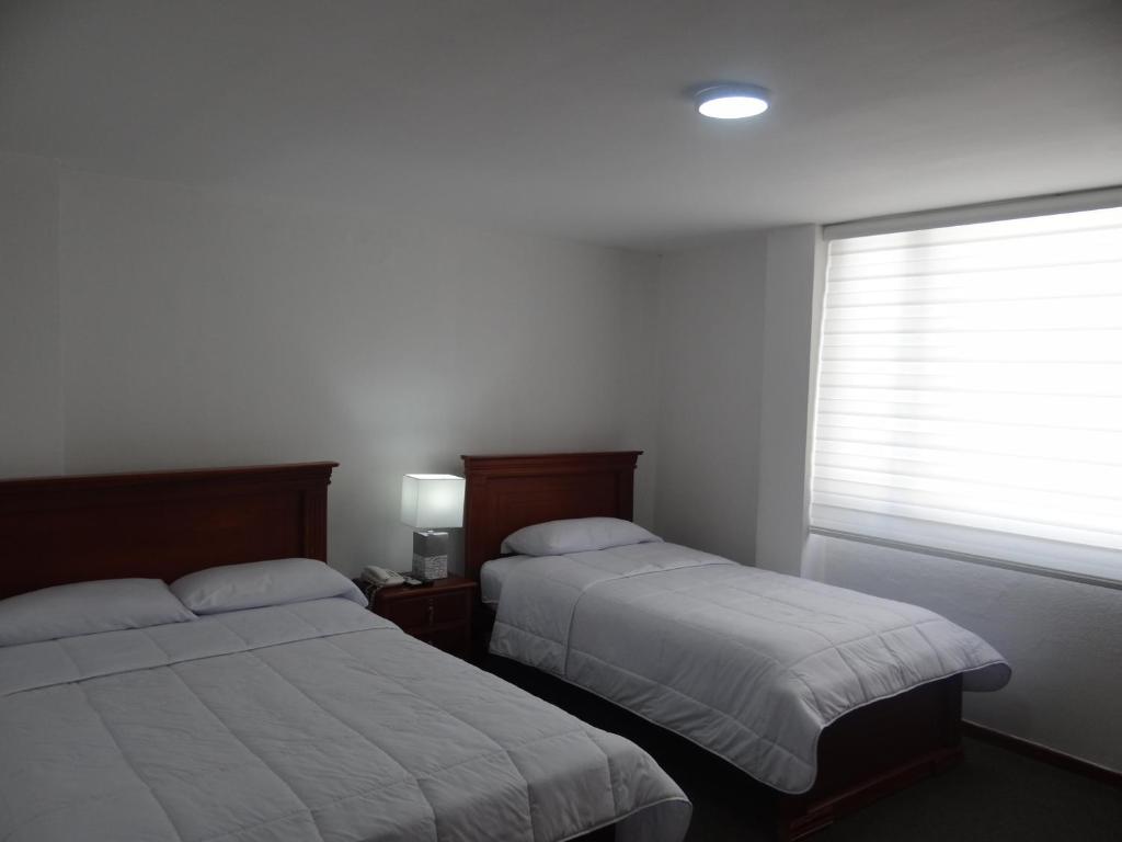 Postel nebo postele na pokoji v ubytování Altura Rooms & Suites