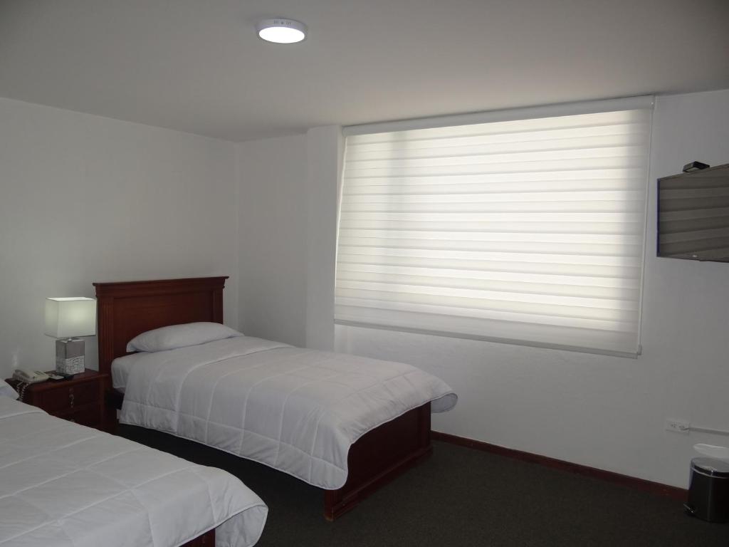 Postel nebo postele na pokoji v ubytování Altura Rooms & Suites
