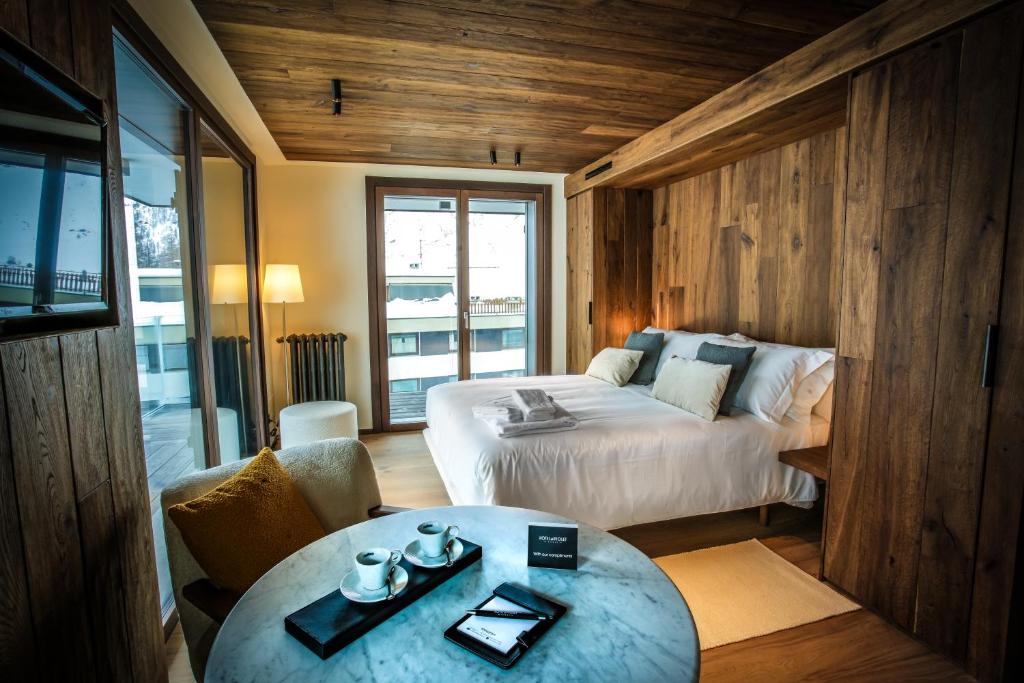 Postel nebo postele na pokoji v ubytování Hotel al Piolet