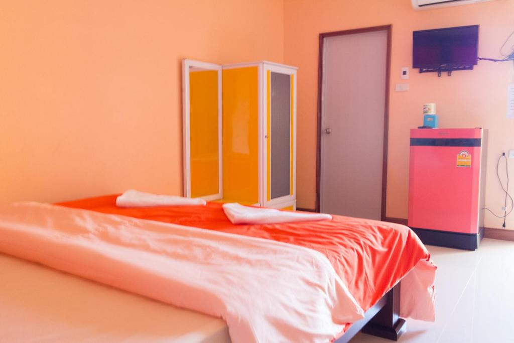 Postel nebo postele na pokoji v ubytování Rak Ban Kerd House