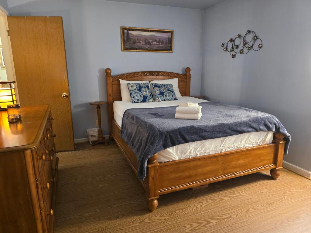a bedroom with a bed with blue pillows and a table at Entire 2-bedroom, 2 bath home with parking and newly renovated floors in Canton